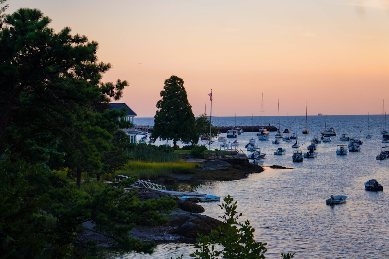 scenic-sunset-over-tranquil-harbor-with-boats-32618831
